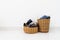 Different shape of wicker basket full of laundry clothes in clean white wall background inside bedroom.