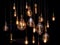 Different shaped vintage light bulbs on black background