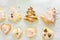 Different shapes of shortbread vanilla Christmas sugar cookies made and decorated by kids with icing chocolate ganache