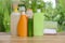 Different shower gel bottles and towels on wooden table