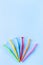 Different size interdental brush angles on blue background, vertical, copy space