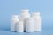 Different sizes of blank white plastic bottles of medicine pills or supplements