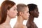 Different skin tones. Side view of three beautiful multicultural young women.Two caucasian and african half naked women