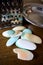 Different soaps and remnants on wooden table with metal grater and dish, preparation for grated soap, lot of solid soap for hygien