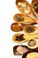 Different spice types on a wooden spoon. Sale of spices. Spices on a white background.