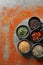 Different spices, silhouettes of fork and plate on grey table, flat lay