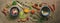 Different spices in spoons, bowls on a brown rustic background. Condiments for cooking. Top view