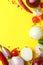 Different spicy vegetables on yellow background, space for text