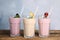 Different tasty milk shakes on table