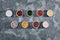 Different tasty sauces in bowls, various sauces on gray stone background, top view