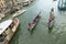 Different transportation boats like Taxi, vaporetto and gondola with tourists at the canale Grande in Venice, Italy