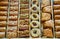 Different type of arabian baklava in rows - borma nest ush-el-bul-bul asabi full screen