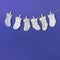 different type baby s sock hang clothesline against blue backdrop. High quality photo