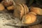 Different types of baked bread on a dark brow table. Bread on a brown background on the table.