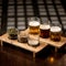 Different types of beer and ingredients for its preparation. Glasses with frothy alcoholic drink and malt on wooden