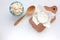 Different types of cheese on white table. Overhead view of cottage cheese and camembert.