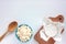 Different types of cheese on white table. Overhead view of cottage cheese and camembert.