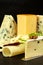 Different types of cheeses on the kitchen table. Preparation of snacks. Healthy food.