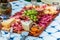 Different types of cheeses, wines, baguettes, fruits and snacks on the table for tasting and holiday scenery