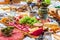 Different types of cheeses, wines, baguettes, fruits and snacks on the table for tasting and holiday scenery