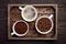 Different types of coffee - ground, grain and beverage on dark wooden background