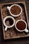 Different types of coffee - ground, grain and beverage on dark wooden background