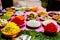 Different types of colorful garnish pan masala used to decorate betel leaf banarasi paan.