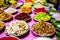 Different types of colorful garnish pan masala used to decorate betel leaf banarasi paan