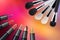 Different types of cosmetics, brush, lipstick on a color background. Top view