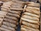 Different types of French baguettes with brown and gold flax grain seeds in bakery