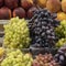 Different types of grapes on the shelves of the farmer`s market, open shelves, showcases. Healthy organic food. Autumn