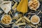 Different types of Italian pasta on a dark wooden rustic background. Mixed dry pasta and spaghetti. Still life. Rustic style. Top