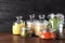 Different types of legumes and cereals in glass jars on table. Organic grains