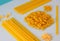 Different types of pasta, blue background.