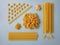 Different types of pasta, blue background. Food knolling, top view.