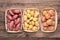 Different types of potatoes in boxes on wooden rustic table