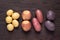 Different types of potatoes on dark wooden rustic table