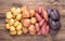 Different types of potatoes on  wooden rustic table