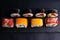 Different types of rolls stand on a black granite board for sushi on a black background