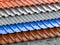 Different types of roof coating. Background from layers of sheet metal  profiles, ceramic tiles, asphalt roofing shingles and