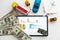 different types of toy cars and a tablet, money