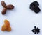 Different useful dried fruits on a white background. Prunes, dried apricots, dates and raisins. Appetizing picture for fruit