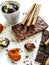 Different varieties of chocolate, chocolate tubes and cocoa on a white table