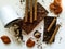 Different varieties of chocolate, chocolate tubes and cocoa on a white table