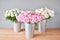 Different varieties of peonies in a metal vases. Beautiful peony flower for catalog or online store. Floral shop concept