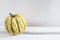 Different varieties of pumpkins lie on white shelf of the rack in the kitchen interior