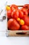 Different varieties of tomatoes on a wooden tray. Colorful red and yellow fresh ripe tomatoes