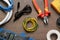 Different wires and electrician\\\'s tools on wooden table, flat lay