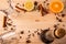 Differential focus. Glasses for mulled wine, a cork bottle with wine, anise flowers, cloves, cinnamon sticks, lemon and orange on