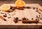 Differential focus. Spices for a mulled wine, fragrant cinnamon sticks, anise flowers, nutmegs, cloves, lemon and orange on